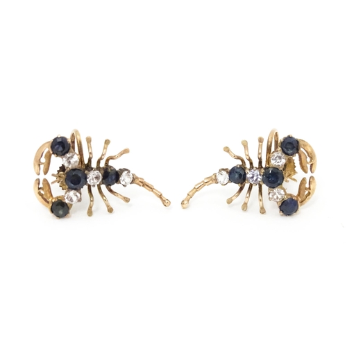 667 - A pair of vintage yellow metal earrings formed as lobsters set with blue and white stones. Approx. 1... 