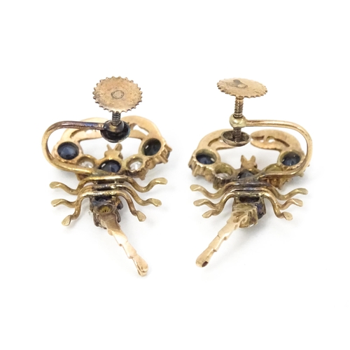 667 - A pair of vintage yellow metal earrings formed as lobsters set with blue and white stones. Approx. 1... 