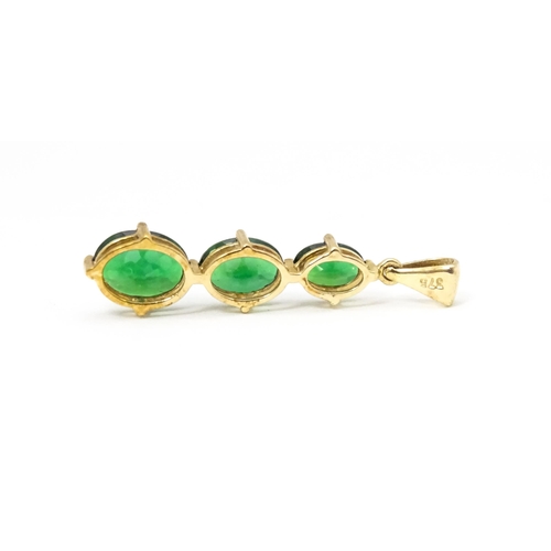 670 - A 9ct gold pendant set with three graduated green stones. Approx. 1 1/42 long