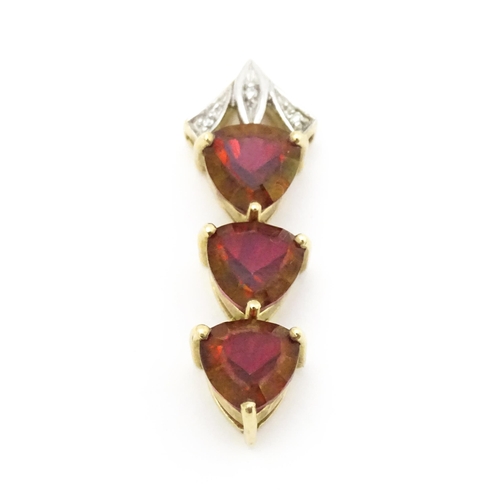 675 - A 9ct gold pendant set with cherry topaz and diamonds. Approx. 1 1/2