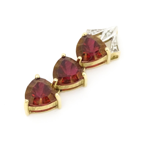 675 - A 9ct gold pendant set with cherry topaz and diamonds. Approx. 1 1/2