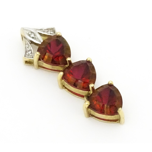 675 - A 9ct gold pendant set with cherry topaz and diamonds. Approx. 1 1/2