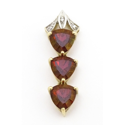 675 - A 9ct gold pendant set with cherry topaz and diamonds. Approx. 1 1/2