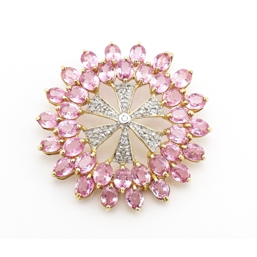 680 - A 9ct gold pendant set with diamonds and pink sapphires. Approx. 1 1/4