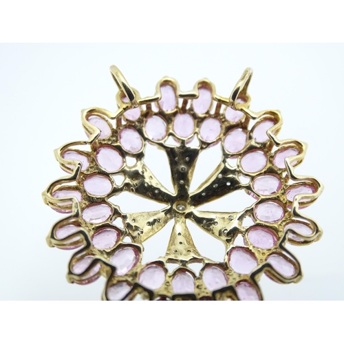 680 - A 9ct gold pendant set with diamonds and pink sapphires. Approx. 1 1/4