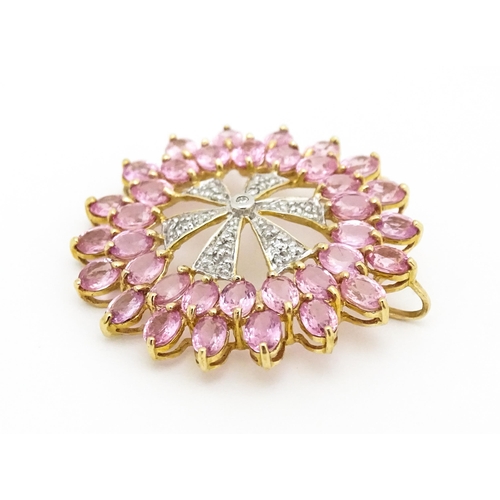 680 - A 9ct gold pendant set with diamonds and pink sapphires. Approx. 1 1/4