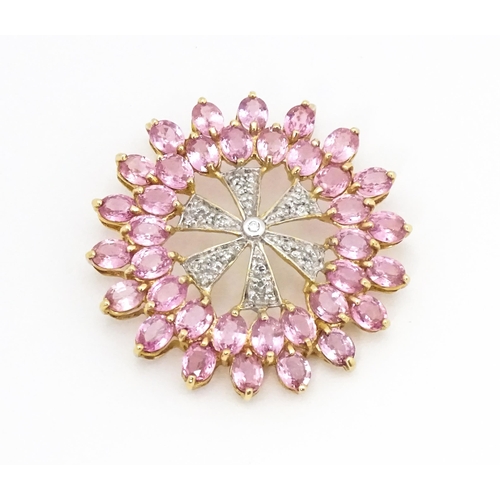 680 - A 9ct gold pendant set with diamonds and pink sapphires. Approx. 1 1/4