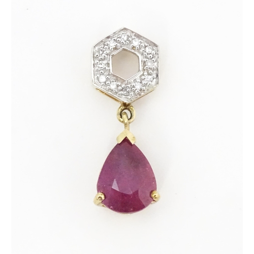 685 - A 9ct gold pendant set with diamonds and red stone drop. Approx. 1