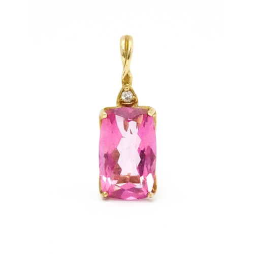 704 - A 9ct gold pendant set with large central pink stone and white stone above. Approx. 1 1/4