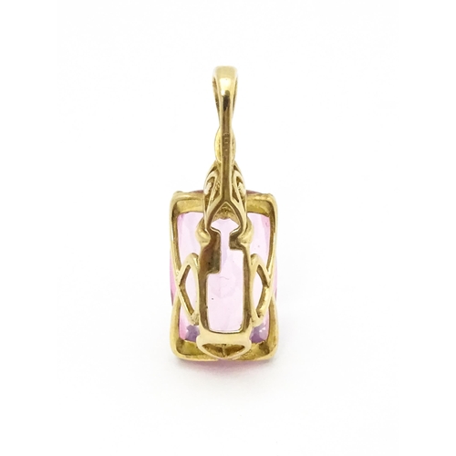 704 - A 9ct gold pendant set with large central pink stone and white stone above. Approx. 1 1/4