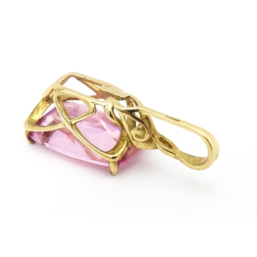 704 - A 9ct gold pendant set with large central pink stone and white stone above. Approx. 1 1/4