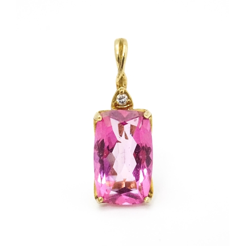 704 - A 9ct gold pendant set with large central pink stone and white stone above. Approx. 1 1/4