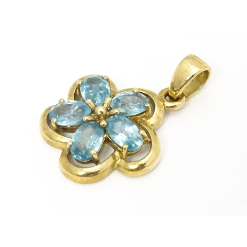 707 - A 9ct gold pendant set with zircons in a floral setting. Approx. 11