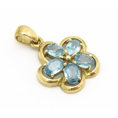 707 - A 9ct gold pendant set with zircons in a floral setting. Approx. 11