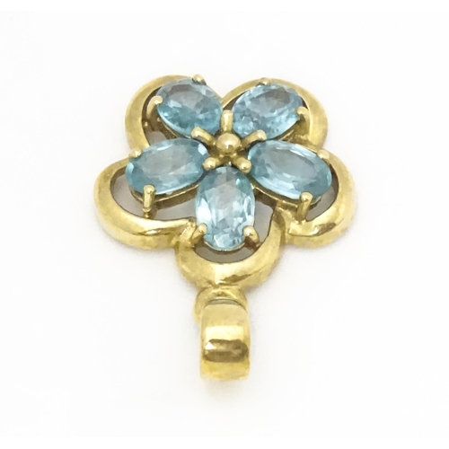 707 - A 9ct gold pendant set with zircons in a floral setting. Approx. 11