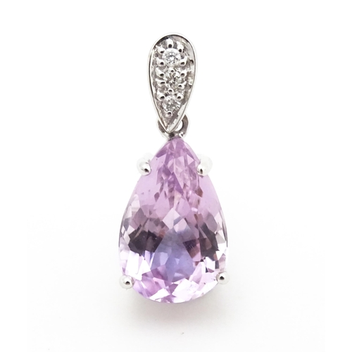 710 - An 18ct white gold pendant set with diamonds and facet pink drop. Approx. 3/4