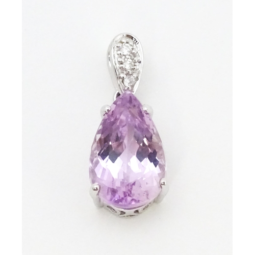 710 - An 18ct white gold pendant set with diamonds and facet pink drop. Approx. 3/4