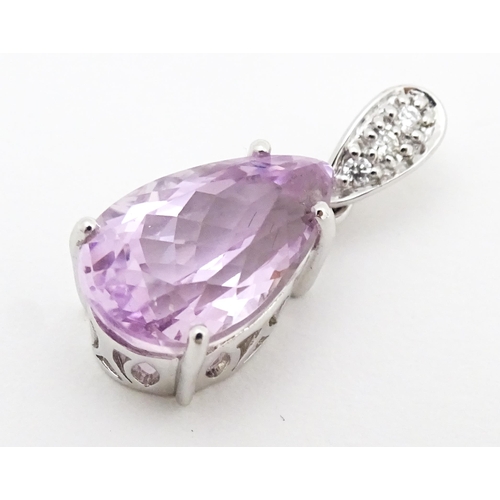 710 - An 18ct white gold pendant set with diamonds and facet pink drop. Approx. 3/4