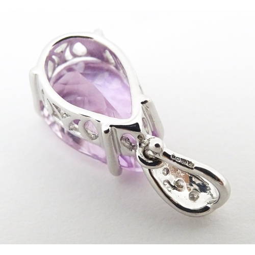 710 - An 18ct white gold pendant set with diamonds and facet pink drop. Approx. 3/4