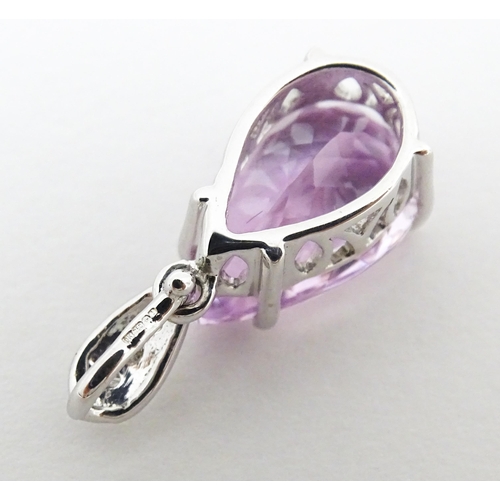 710 - An 18ct white gold pendant set with diamonds and facet pink drop. Approx. 3/4