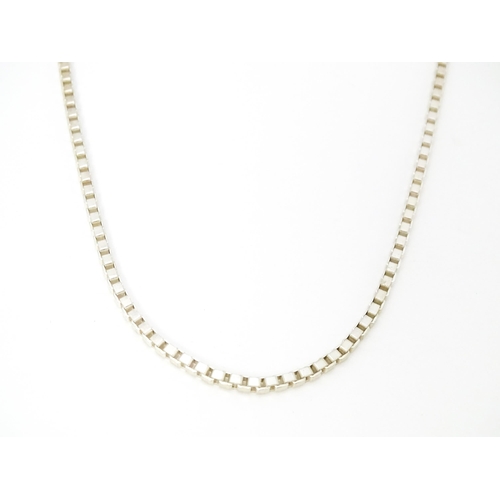 711 - A silver and white metal box link chain necklace, Approx 20