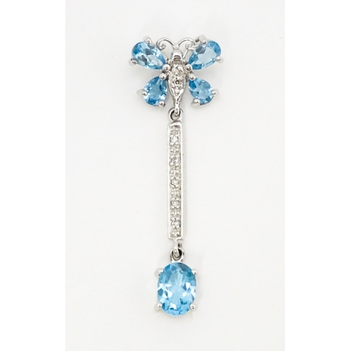 712 - A 9ct white gold pendant set with topaz, diamond, etc. with butterfly detail. Approx. 1 1/4