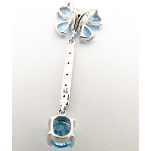 712 - A 9ct white gold pendant set with topaz, diamond, etc. with butterfly detail. Approx. 1 1/4