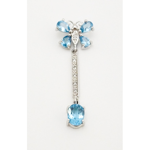 712 - A 9ct white gold pendant set with topaz, diamond, etc. with butterfly detail. Approx. 1 1/4