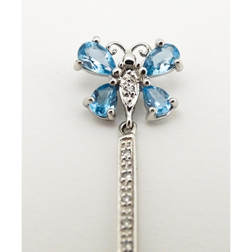 712 - A 9ct white gold pendant set with topaz, diamond, etc. with butterfly detail. Approx. 1 1/4