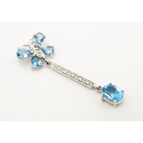 712 - A 9ct white gold pendant set with topaz, diamond, etc. with butterfly detail. Approx. 1 1/4