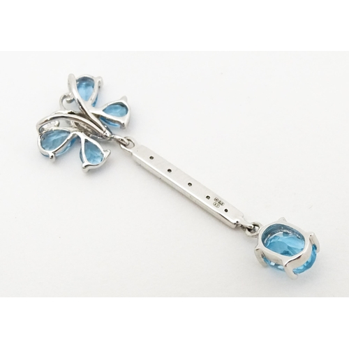 712 - A 9ct white gold pendant set with topaz, diamond, etc. with butterfly detail. Approx. 1 1/4