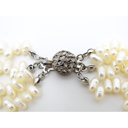 714 - A four strand pearl necklace / choker. Approx 15