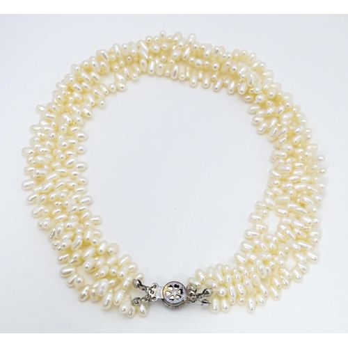 714 - A four strand pearl necklace / choker. Approx 15