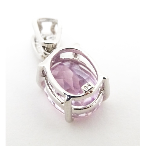 715 - A 9ct white gold pendant set with amethyst and diamonds. Approx. 3/4