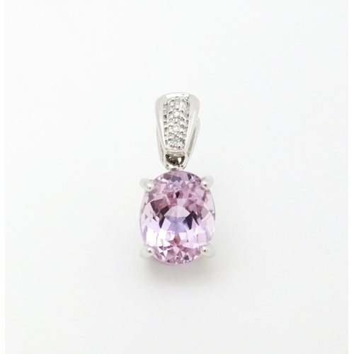 715 - A 9ct white gold pendant set with amethyst and diamonds. Approx. 3/4