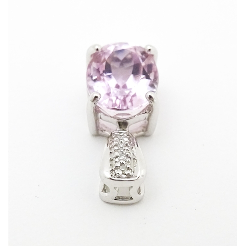 715 - A 9ct white gold pendant set with amethyst and diamonds. Approx. 3/4