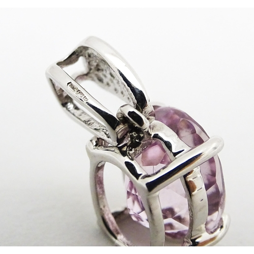 715 - A 9ct white gold pendant set with amethyst and diamonds. Approx. 3/4