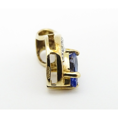 717 - A 9ct gold pendant set with tanzanite and diamonds. Approx. 1/2