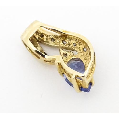 717 - A 9ct gold pendant set with tanzanite and diamonds. Approx. 1/2