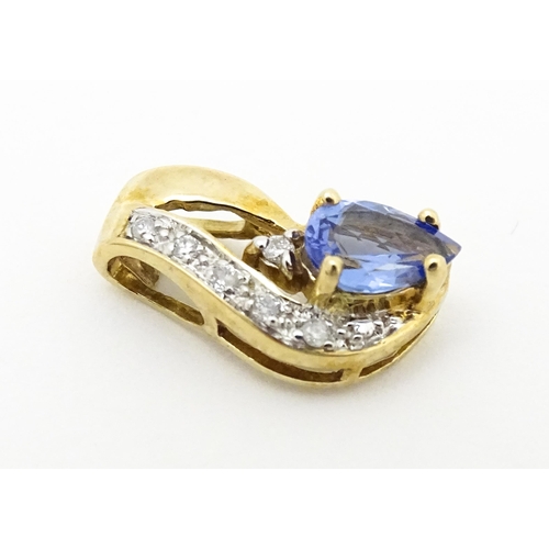 717 - A 9ct gold pendant set with tanzanite and diamonds. Approx. 1/2