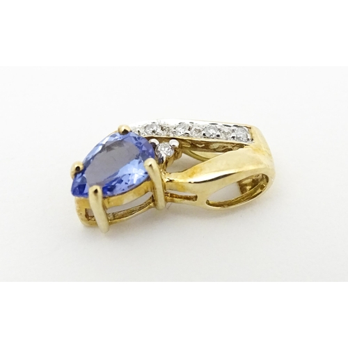 717 - A 9ct gold pendant set with tanzanite and diamonds. Approx. 1/2