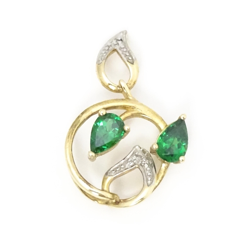 720 - A 9ct gold pendant set with diamonds and green stones. Approx. 1