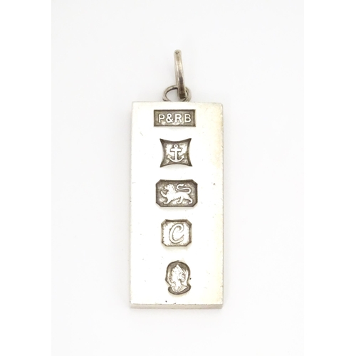 757 - A silver pendant of ingot form hallmarked Birmingham 1977 with silver Jubilee mark, maker P & R Bush... 