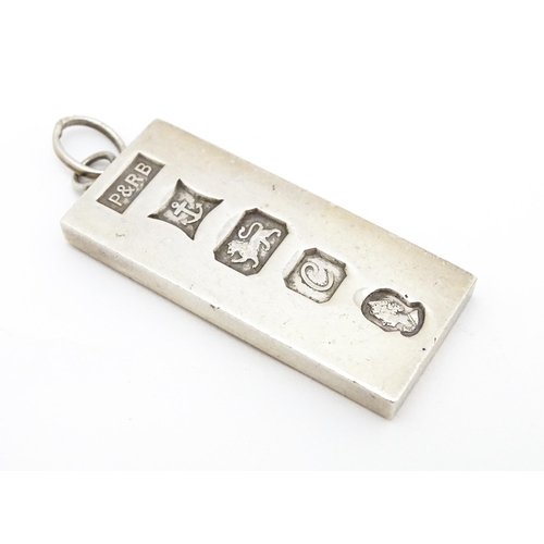 757 - A silver pendant of ingot form hallmarked Birmingham 1977 with silver Jubilee mark, maker P & R Bush... 