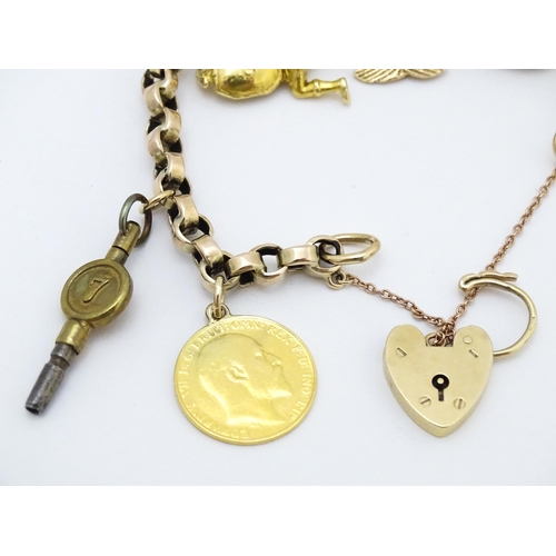 768 - A 9ct gold charm bracelet set with various gold and gilt metal charms to include a half sovereign, f... 