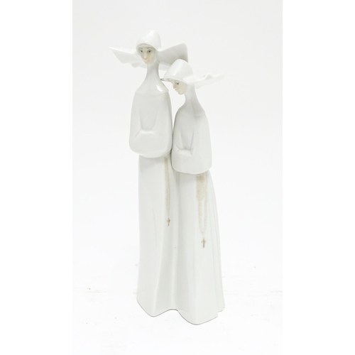 101 - A Lladro figural group depicting two nuns, model no. 4611. Approx. 13