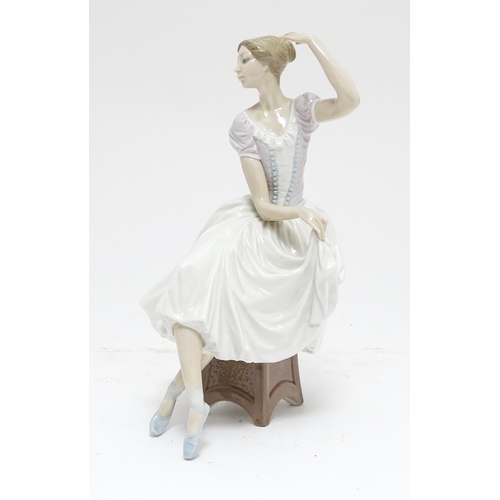 104 - A Lladro figure Weary Ballerina, model no. 5275, depicting a seated ballerina. Marked under. Approx.... 