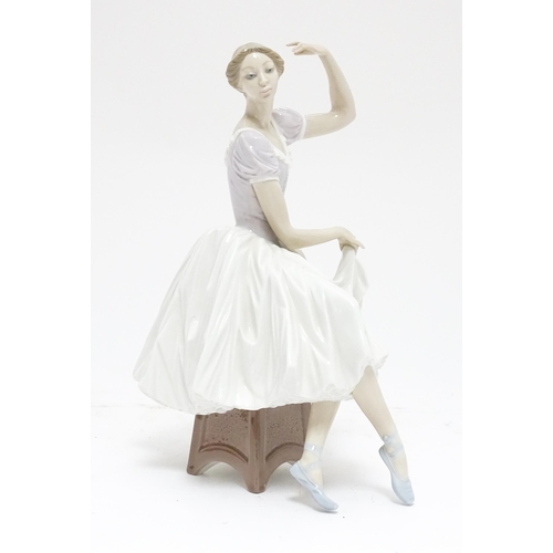 104 - A Lladro figure Weary Ballerina, model no. 5275, depicting a seated ballerina. Marked under. Approx.... 