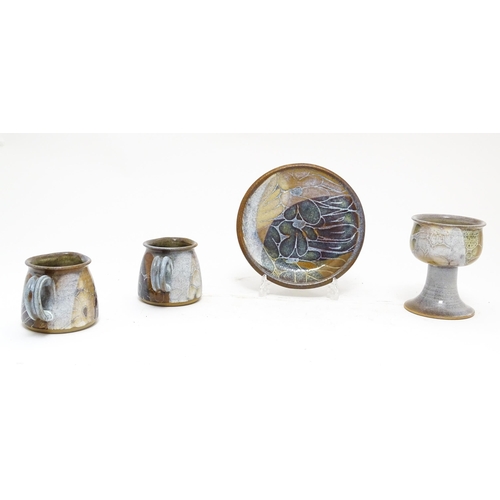 111A - Four Crick Pottery studio pottery wares by Diana Worthy comprising two jugs, a small plate and a gob... 