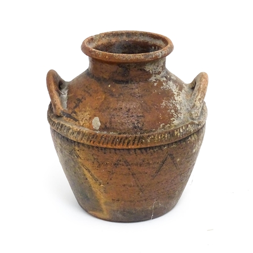 114A - A stoneware pot / vessel with twin handles and traces of geometric detail. Approx. 8